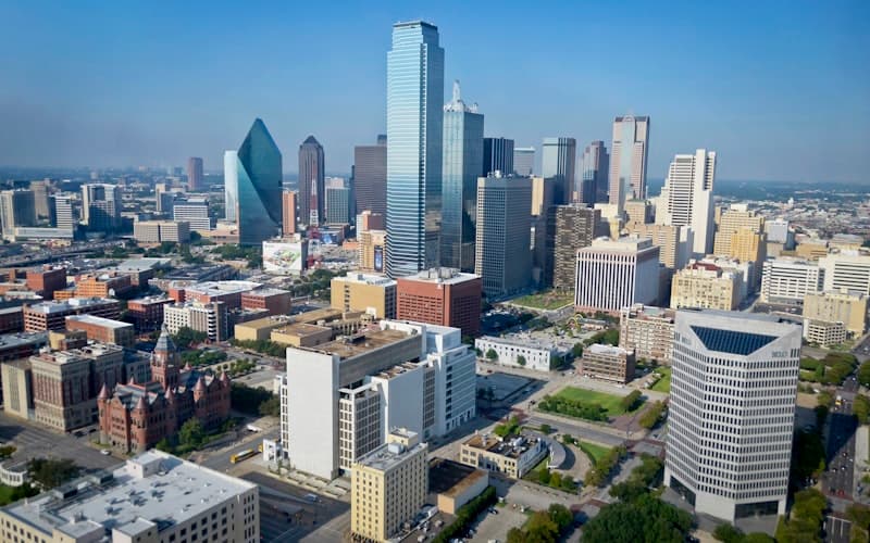 Retail storefronts in a modern shopping district at dusk